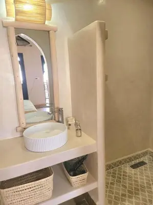 a bathroom with a sink and a mirror at Riad Isahiac avec piscine en exclusivité in Marrakech