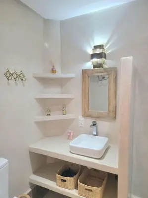 a white bathroom with a sink and a mirror at Riad Isahiac avec piscine en exclusivité in Marrakech