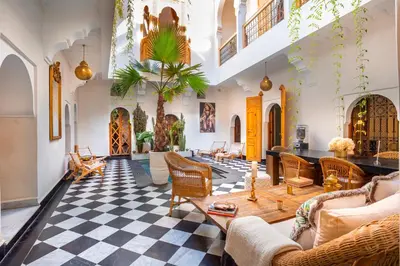 a living room with a black and white checkered floor at Riad LallaBaya in Marrakech