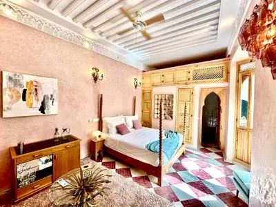 a bedroom with a bed and a tv in a room at Riad LallaBaya in Marrakech