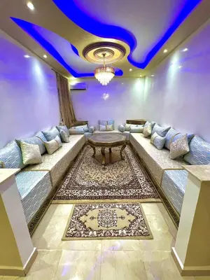 a living room with a couch and a table at Superbe Appartement proche centre marrakech, neuf tout équipé in Marrakech