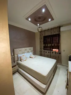 a bedroom with a large white bed in a room at Superbe Appartement proche centre marrakech, neuf tout équipé in Marrakech