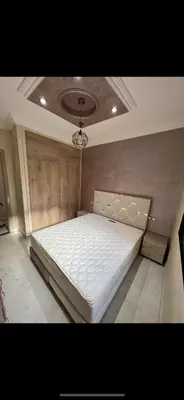 a large white bed in a room with a ceiling at Superbe Appartement proche centre marrakech, neuf tout équipé in Marrakech
