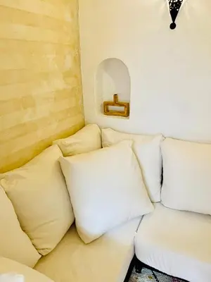 a white couch with pillows in a room at Riad Darna 4 chambres avec piscine et petit déjeuner in Marrakech