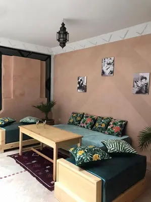 a living room with a couch and a table at Riad Baroud in Marrakech