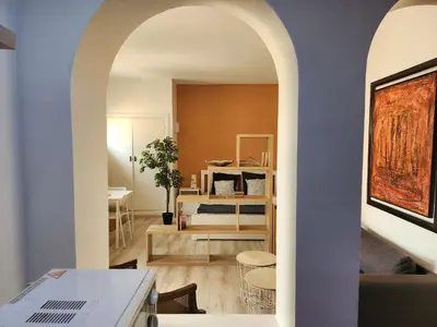 a living room with an archway leading to a bedroom at Suite dans la palmeraie refaite à neuf grande Terrasse Dar Dmana in Marrakech