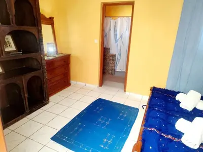 a living room with a blue mat on the floor at Riad Izza in Marrakech