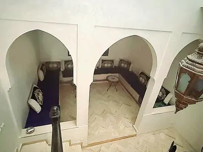 a room with two beds and an archway in it at Riad Izza in Marrakech
