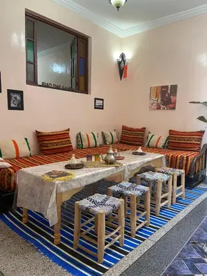 a living room with a long table and a couch at Riad dar sahrawi in Marrakech