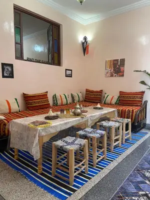 a living room with a large table and chairs at Riad dar sahrawi in Marrakech