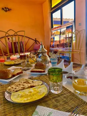 a table topped with plates of food and drinks at Riad dar sahrawi in Marrakech