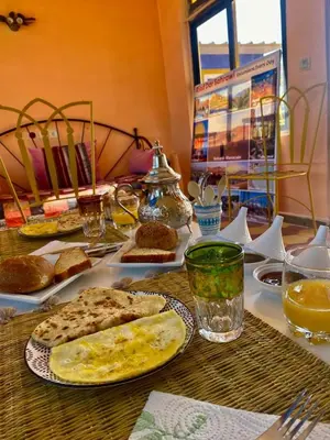 a table topped with plates of food and drinks at Riad dar sahrawi in Marrakech