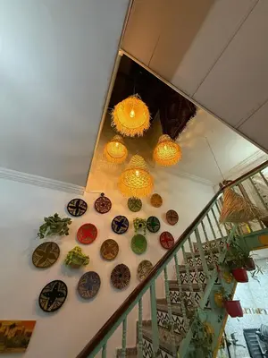 a group of chandeliers and plates on a staircase at Riad dar sahrawi in Marrakech