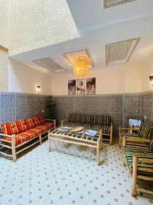 a living room with couches and chairs in a room at Private Riad 3ch Salon, Terrasse avec Jacuzzi , à Jemaa El Fna in Marrakech