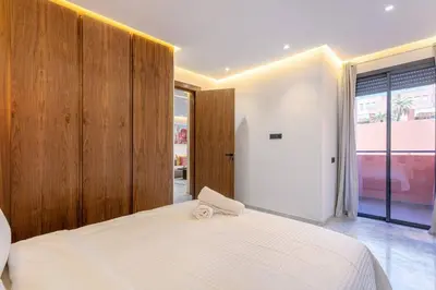 a bedroom with a white bed and a large window at Contemporary luxe, heart of Gueliz fibre optq IPTV in Marrakech