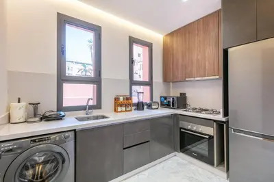 a kitchen with a washer and dryer in it at Contemporary luxe, heart of Gueliz fibre optq IPTV in Marrakech