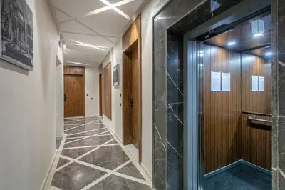 a corridor of a hallway with a door and a tile floor at Contemporary luxe, heart of Gueliz fibre optq IPTV in Marrakech