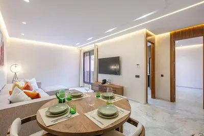 a living room with a table and a couch at Contemporary luxe, heart of Gueliz fibre optq IPTV in Marrakech
