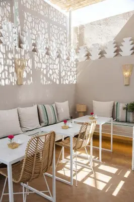 a dining room with white tables and chairs at Riad M17 & Spa - Médina in Marrakech