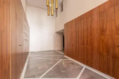 a hallway with wooden doors and a tiled floor at Peaceful Living: Chic Apartment, Prime Location in Marrakech