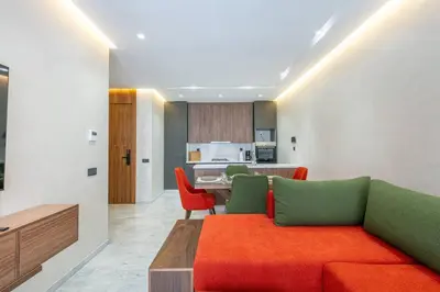 a living room with a couch and a kitchen at Peaceful Living: Chic Apartment, Prime Location in Marrakech