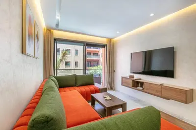 a living room with a couch and a flat screen tv at Peaceful Living: Chic Apartment, Prime Location in Marrakech