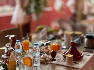 a table topped with bottles of water and orange juice at Riad La Bigarade in Marrakech