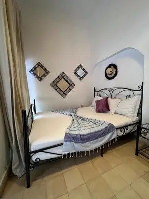 a bedroom with a black and white bed at Riad el Adraoui in Marrakech
