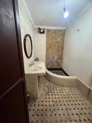 a bathroom with a sink and a bath tub at Riad el Adraoui in Marrakech