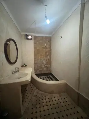 a bathroom with a sink and a bath tub at Riad el Adraoui in Marrakech