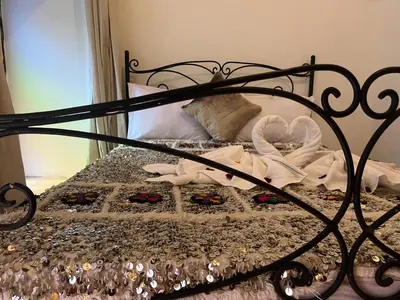 a bed with a black frame and some towels on it at Riad el Adraoui in Marrakech