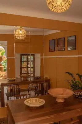 a kitchen with a table and chairs and a dining room at Riad Le Petit Bacha in Marrakech