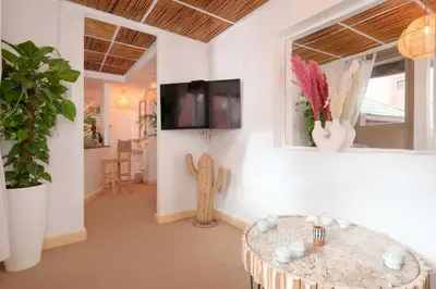 a living room with a table and a tv at Rooftop centre ville Marrakech in Marrakech