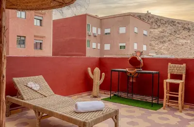a patio with a cactus and a table and chairs at Rooftop centre ville Marrakech in Marrakech