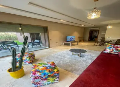 a living room with a couch and a table at Appartement Prestigia Golf City Marrakech - Porte Agate - Gated community Rez-de-Jardin in Marrakech