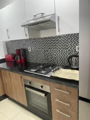 a kitchen with a stove and a counter top at Appartement Prestigia Golf City Marrakech - Porte Agate - Gated community Rez-de-Jardin in Marrakech