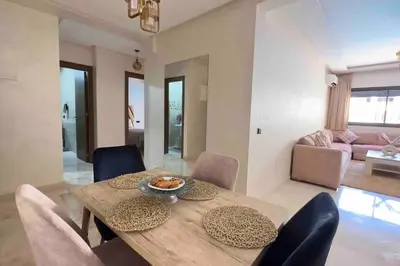 a dining table and chairs in a living room at Glamorous Marrakech in Marrakech