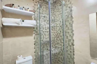 a bathroom with a glass shower with a toilet at Glamorous Marrakech in Marrakech
