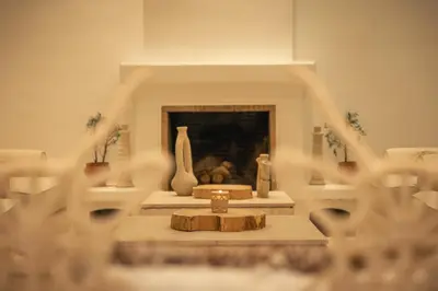 a room with a fireplace with vases on a table at Les Palmiers Boutique Hôtel & Spa in Marrakech