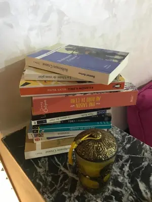 a stack of books sitting on top of a table at Appartement 7 min de l'aéroport de Marrakech in Marrakech