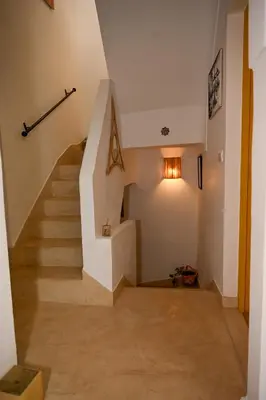 a staircase in a home with a white stair case at Riad Dar Fena By K&G &jacuzzi in Marrakech
