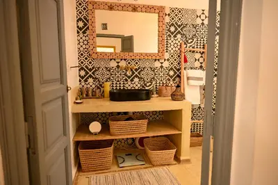 a bathroom with a sink and a mirror at Riad Dar Fena By K&G &jacuzzi in Marrakech