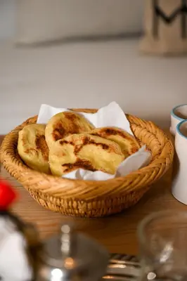 a basket of bread sitting on a table at Riad Dar Fena By K&G &jacuzzi in Marrakech
