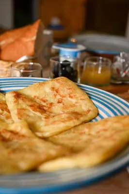two pieces of toast sitting on a blue and white plate at Riad Dar Fena By K&G &jacuzzi in Marrakech