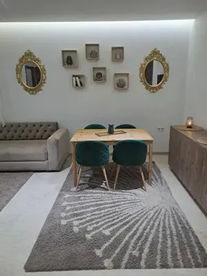 a living room with a table and two chairs at Chez Dar safaa in Marrakech