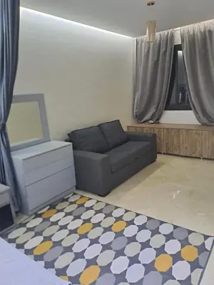 a living room with a couch and a rug at Chez Dar safaa in Marrakech