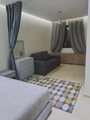 a bedroom with a bed and a couch at Chez Dar safaa in Marrakech