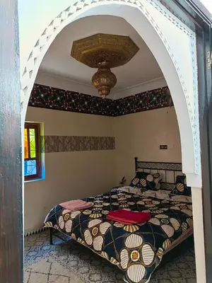 a bedroom with a bed and an archway at Riad Anisse in Marrakech