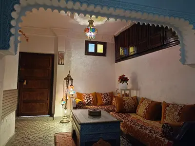 a living room with a couch and a table at Riad Anisse in Marrakech