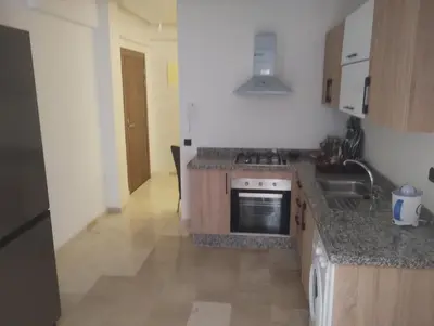 a kitchen with a sink and a stove top oven at Nour 5 marrakech in Marrakech